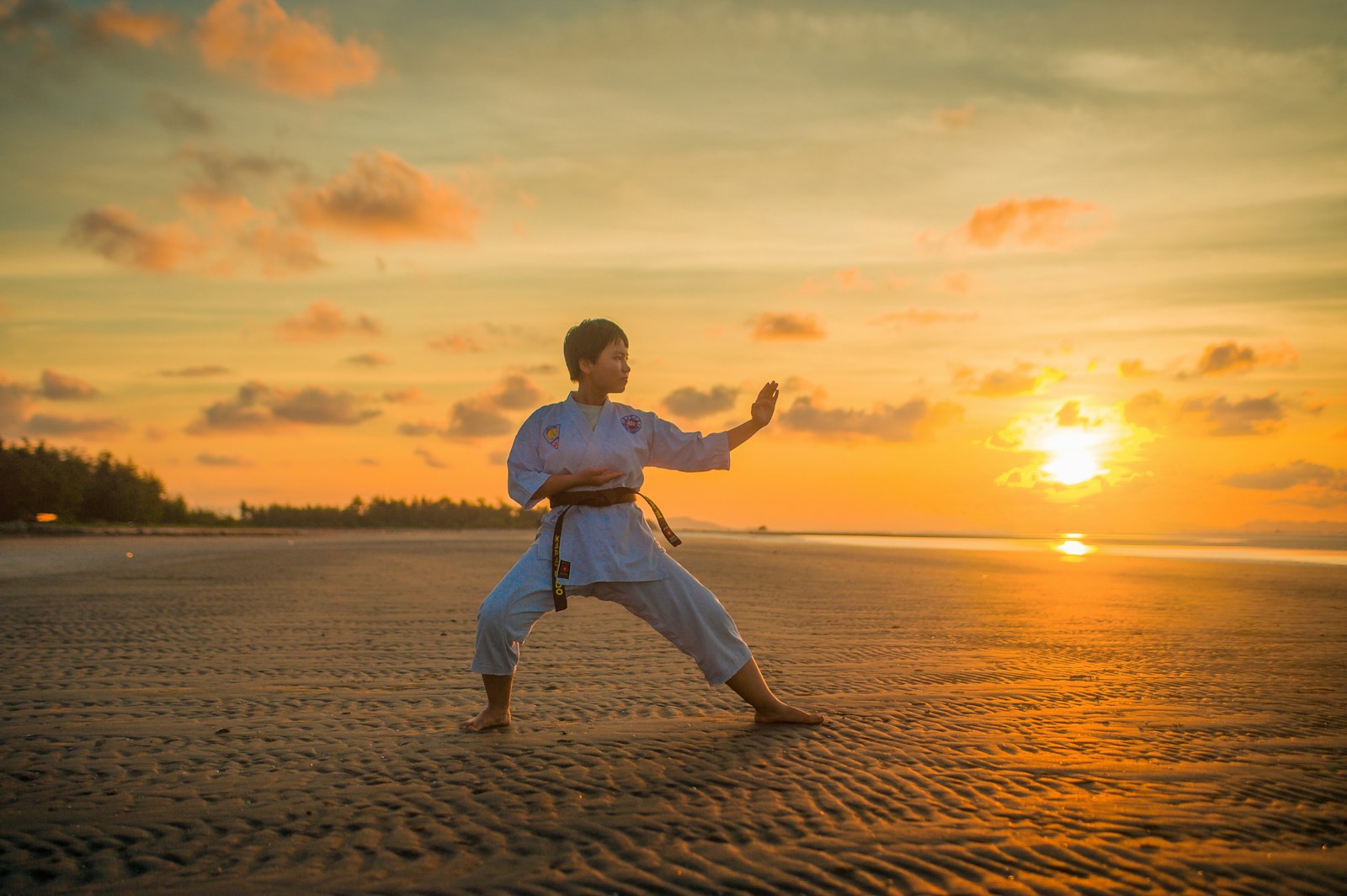 Child practicing karate during golden hour